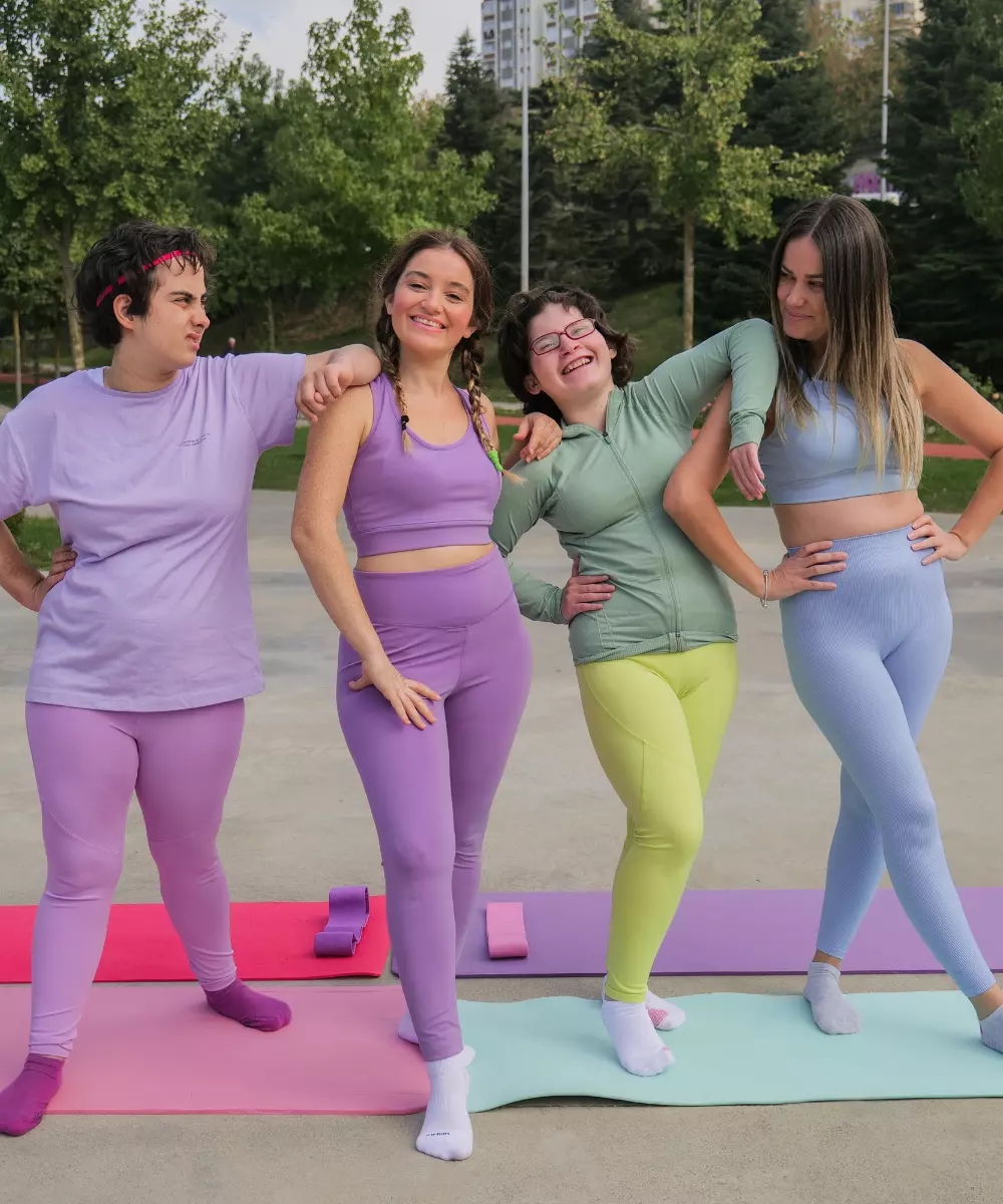 Group of disabled friends standing on yoga mats